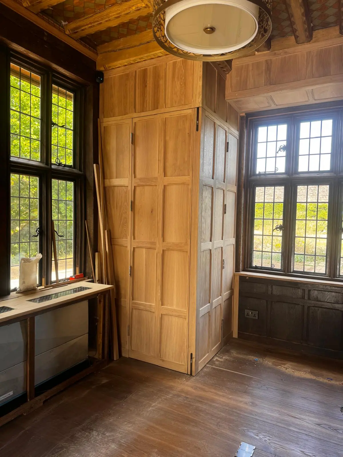 Newly installed panelling in a room, pale unfinished timber