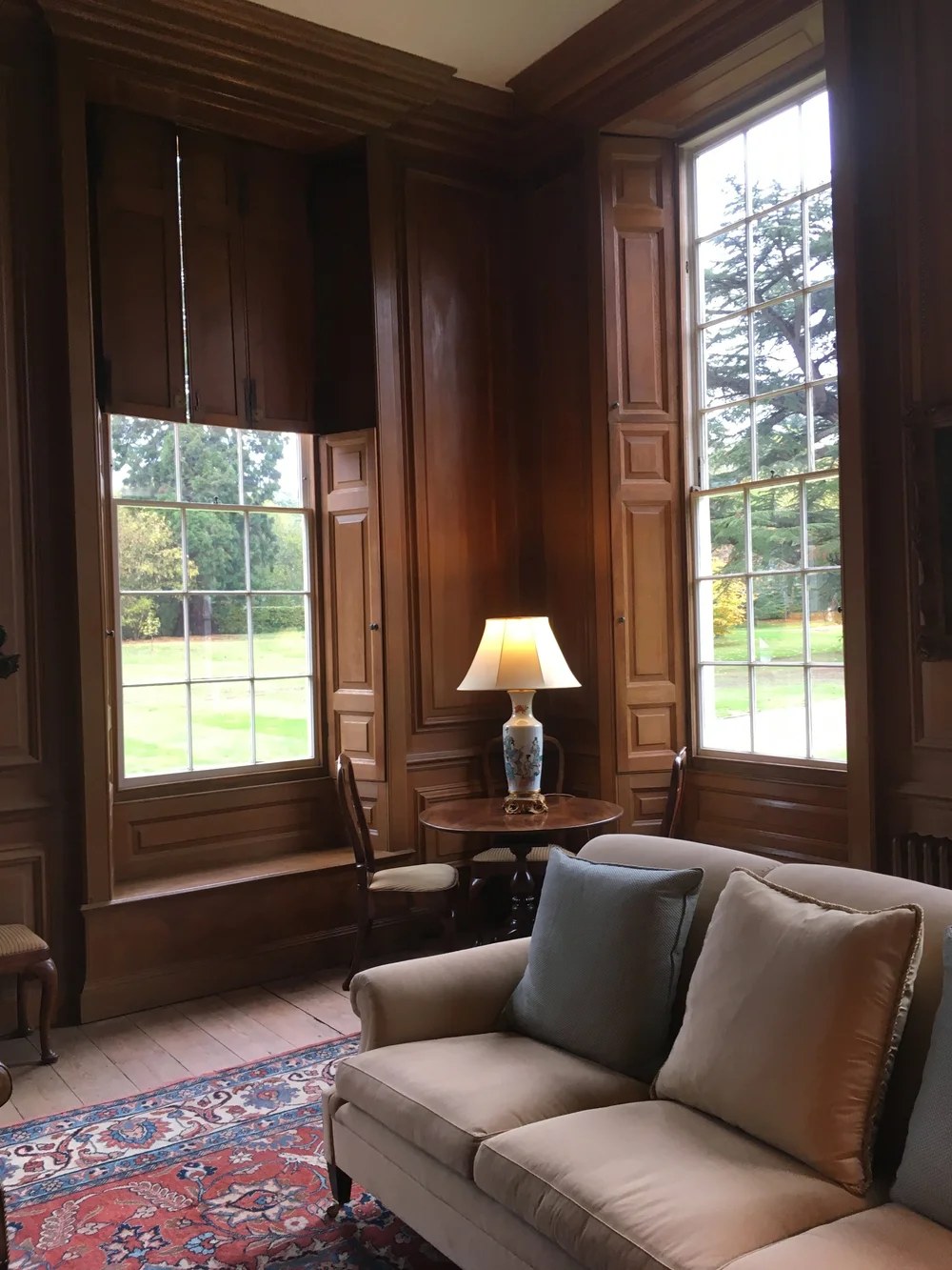 Restored timber panelling and window shutters in a period sitting room