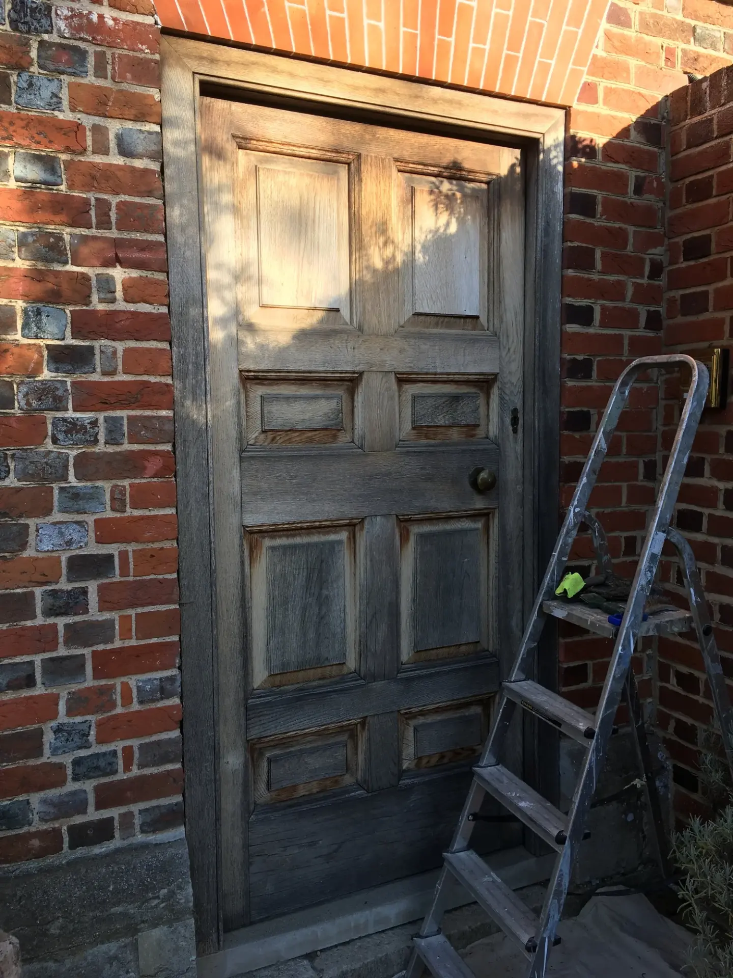 Oak front door before restoration, weathered grey